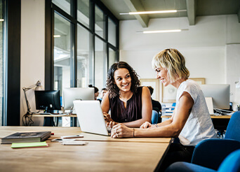 two woman working in an office together