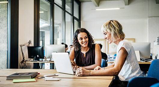 two women working together in an office