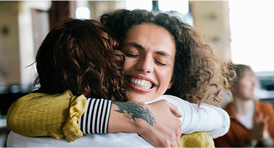 Two woman embraced in a hug