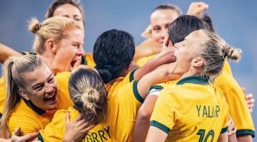 Matildas in a celebratory group hug